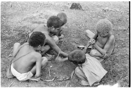 Young boys playing spear game.