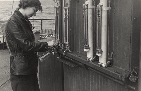Katherine LaFond (née Gehring) drawing a water sample from Nansen bottle for analysis aboard R/V Scripps