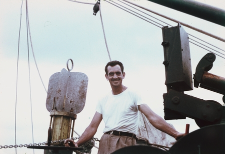 An unidentified crew member of the MidPac expedition shown here posing for a picture on the deck of the R/V Horizon. 1950.