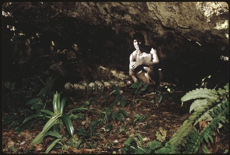 Man in a cave with skulls