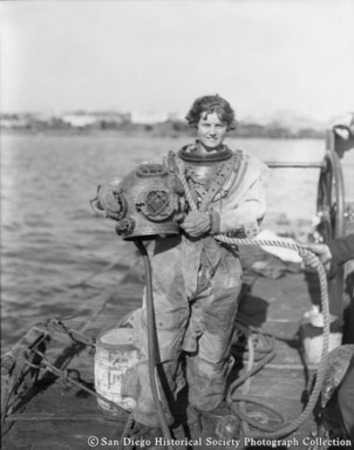 Woman on dock in deep sea diving suit