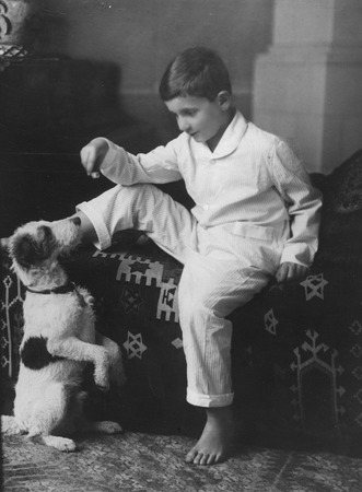 Walter Munk as a young child posing with the family dog, Vienna, Austria