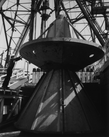Crew member aboard the research vessel D/V Glomar Challenger (ship) checking the developed re-entry cone as it rests upsid...