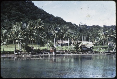 Baluan Island: Mouk village, view from bay, outhouse on stilts (center)