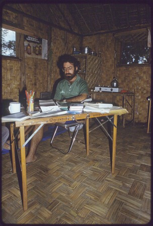 Western Highlands: anthropologist William Heaney working at a folding table