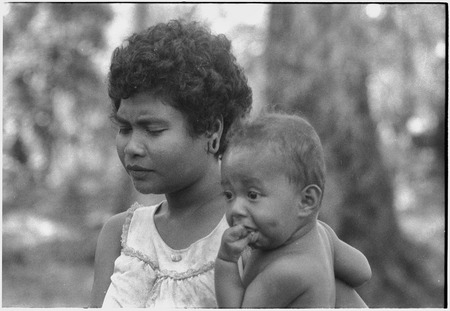 Young woman and infant, woman has large ear piercing