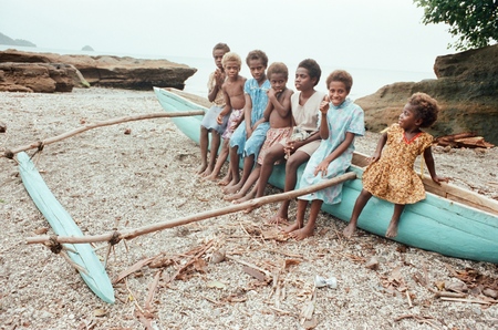 Children sitting on a canoe