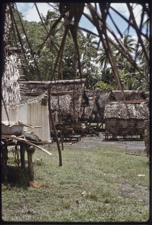 Tukwaukwa village on Kiriwina: houses, fishing nets (l)