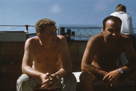 Two unidentified members of the Swan Song Expedition (1961) shown here taking a break on the R/V Argo. 1961.