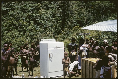 Tabibuga airstrip, crowd of local people around a refrigerator