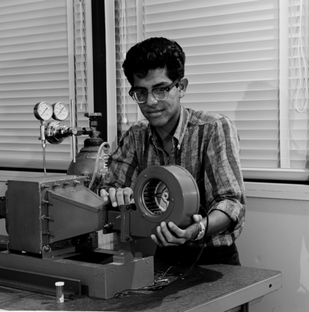 Student in laboratory with instrument, UC San Diego