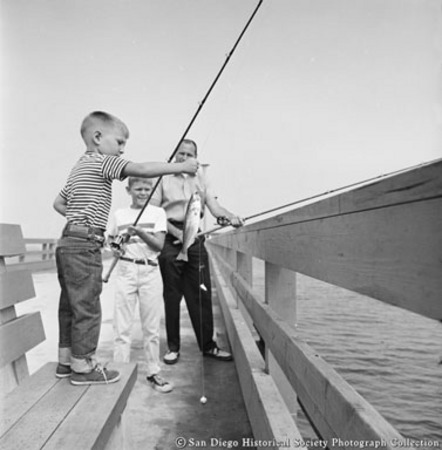 Man and two boys fishing from Ocean Beach pier
