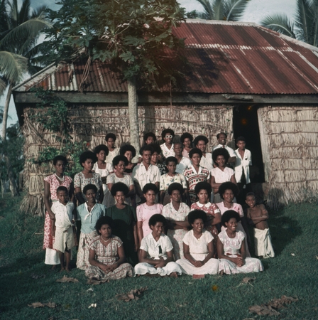 Village group posed outside of a building