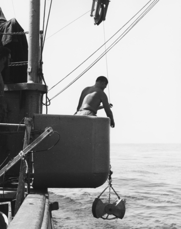Standing in the bucket on the side of the research vessel Spencer F. Baird, Robert H. Parker, Junior Research Ecologist, U...