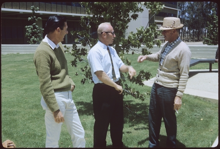 Ted Forbes talks with landscaping staff