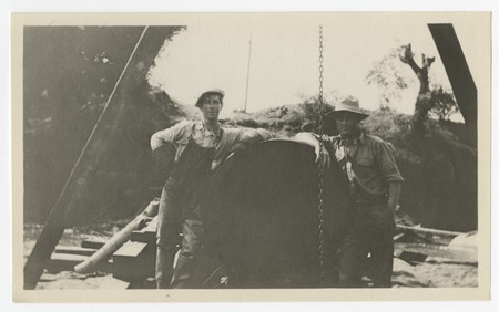 Laborers posing with a steel pipe for the San Diego flume