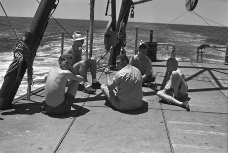 [Men seated on deck of R/V Spencer F. Baird]