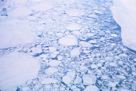 Ice breakup beginning as flight heads southwest over the Bering Sea
