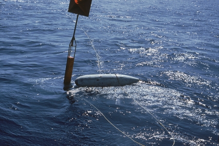 The taut wire buoy tower with the wing tank for buoyancy can be seen here from the R/V Argo during the Swan Song Expeditio...