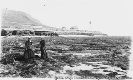 Two women on rocky beach near Point Loma Lighthouse