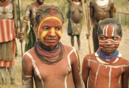 Two girls, their skin painted for a ceremony