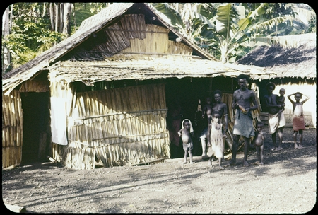 Group in front of a house, village