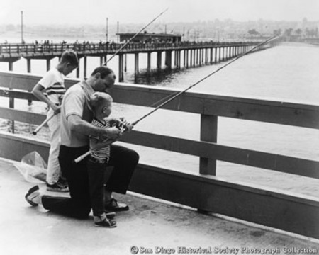 Man and two boys fishing off Ocean Beach pier