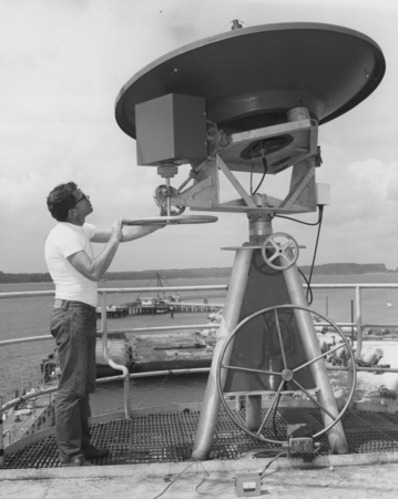 Principal electronics technician David Havens turns the wheel which adjusts vertical angle on the new satellite weather an...