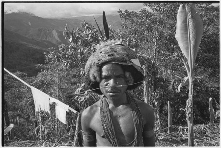 Man with barkcloth cap, pierced nose, bead necklaces and woven armbands