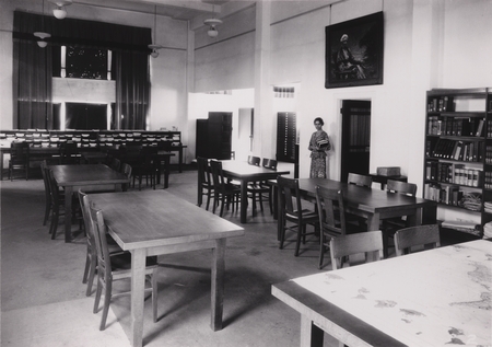 Interior view of the Library for the Scripps Institution of Oceanography, Tillie Genter stands beneath portrait of Ellen B...