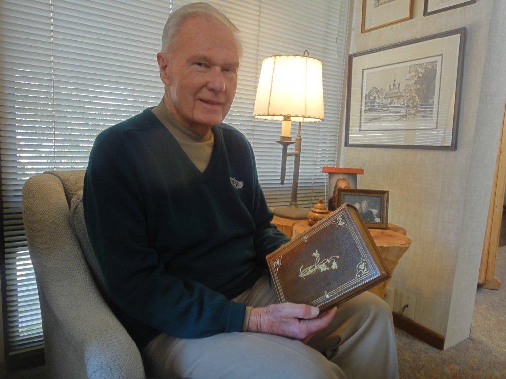 Pat Ford with a book from his ten-volume manuscript edition of John Muir's books.