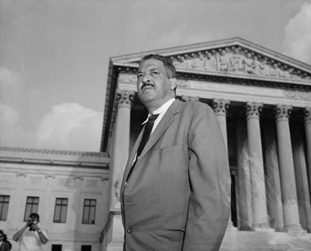 Thurgood Marshall standing on the steps of the Supreme Court in 1958