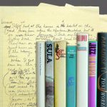 yellow pad with writing and set of books by toni morrison lined up