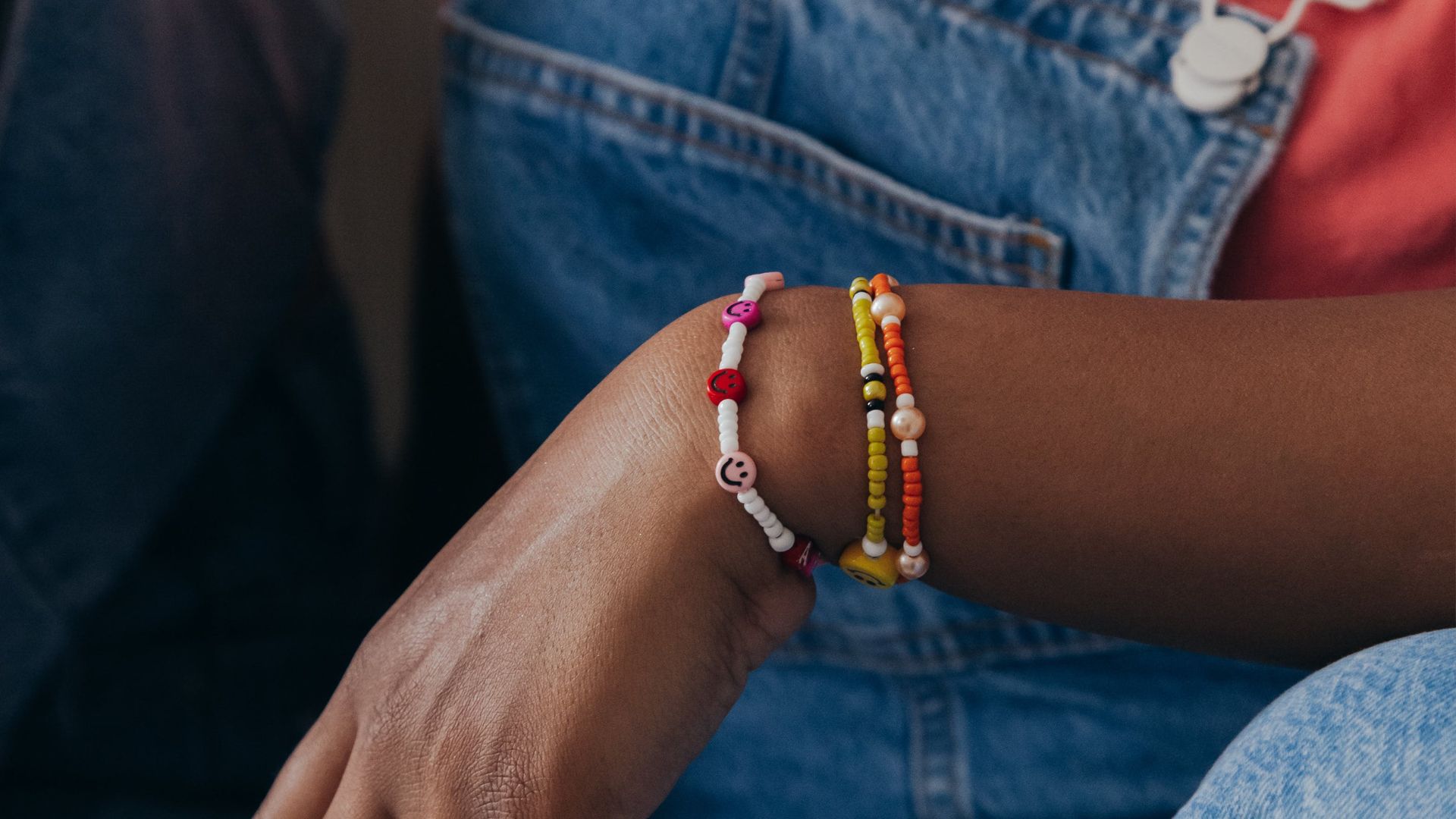 A woman's arm with stacked beaded bracelets