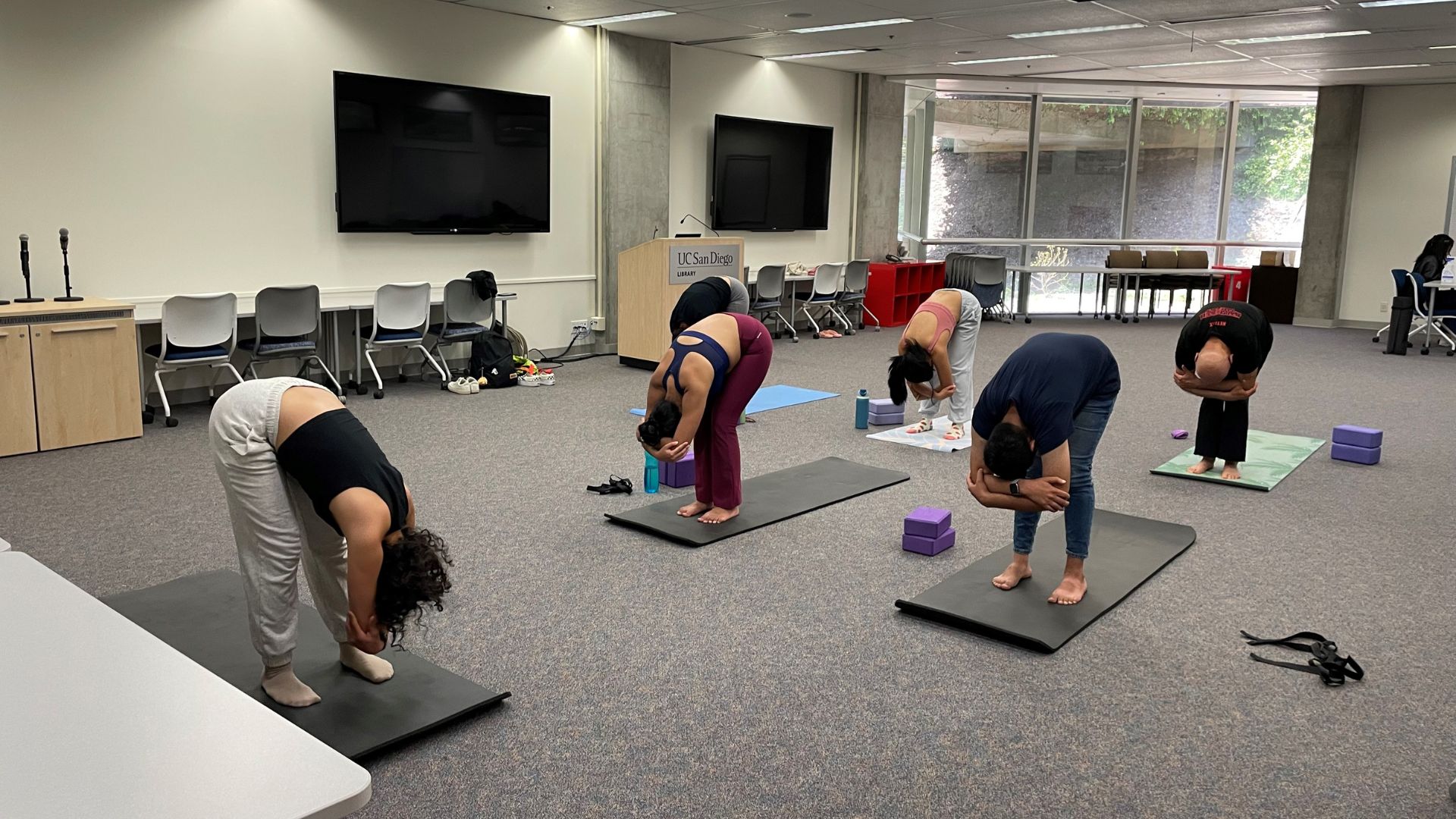 Image of yoga session taking place in the Geisel Meeting Room at Geisel Library,