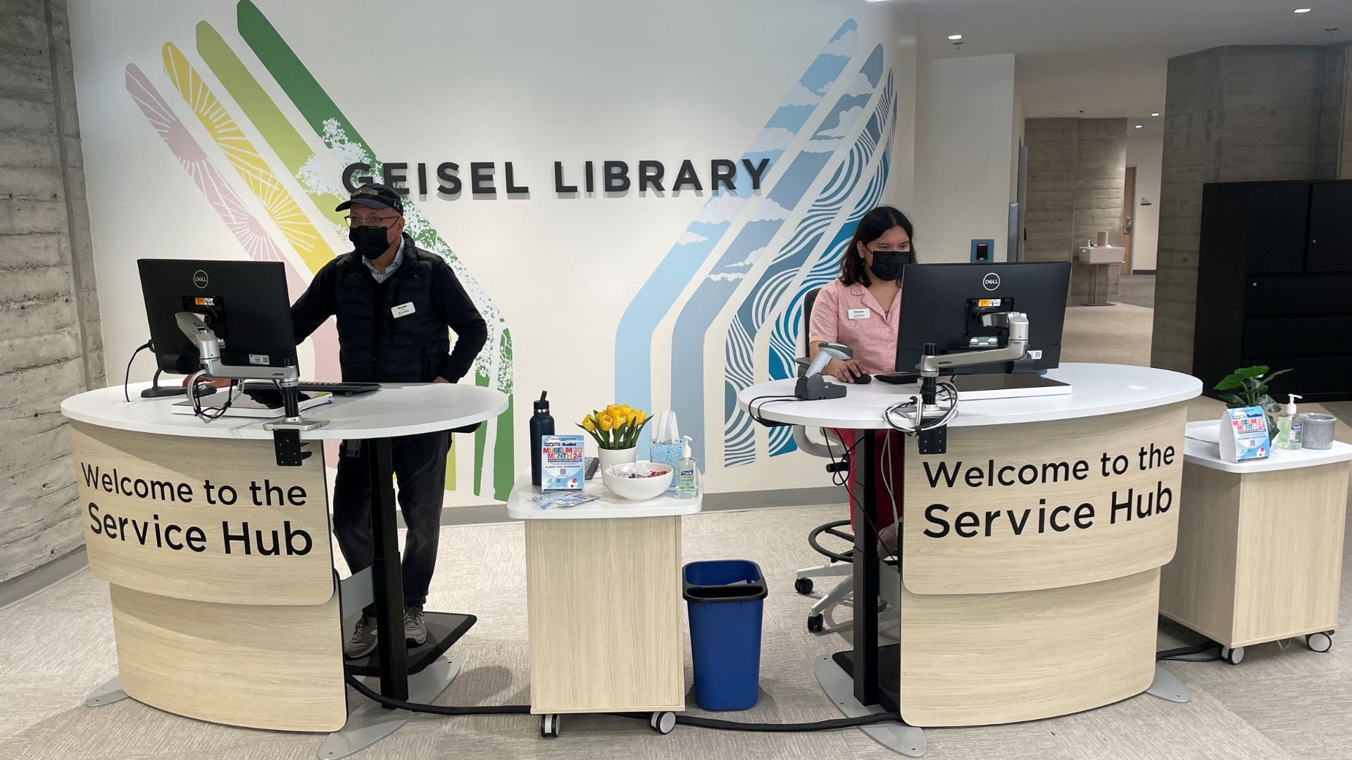 Image of two Service Hub employees at their workstations at Geisel Library
