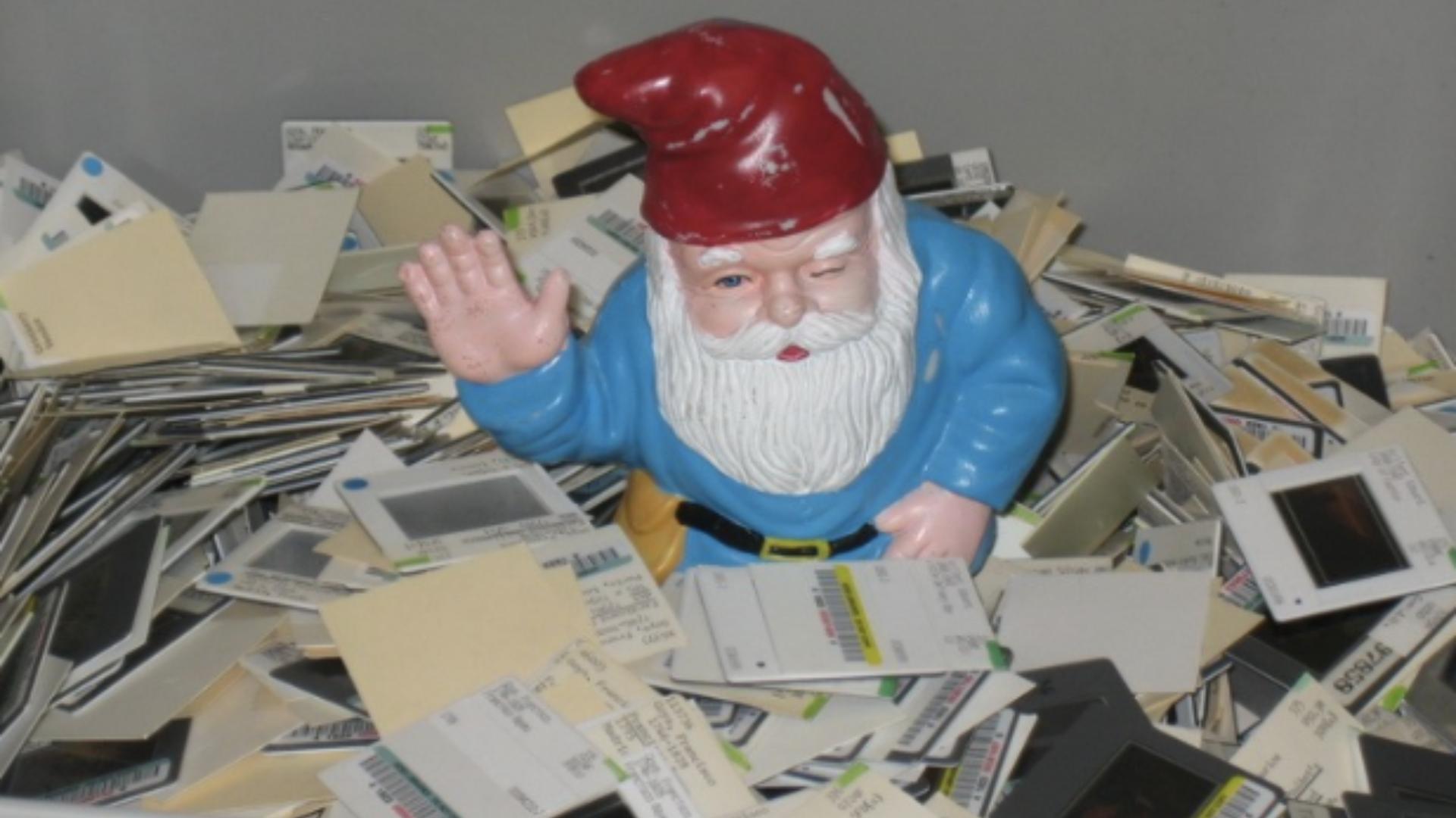 Gnome statue sitting in a bucket of slides